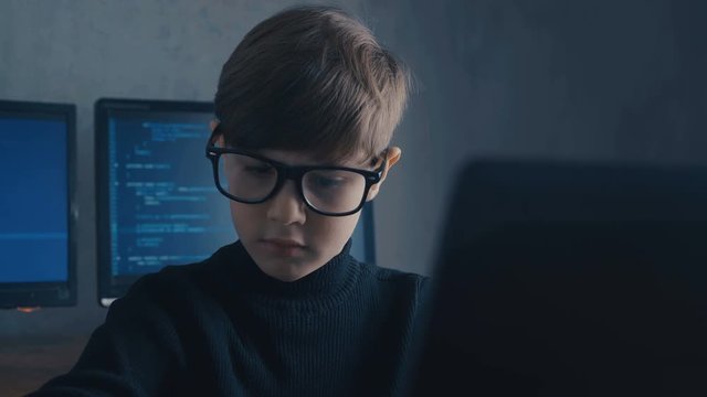 Boy Wunderkind Hacker Hacks Computer Systems. in Data Center