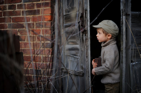 The little boy is playing hide and seek. The child wants to hide from someone.