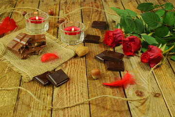 valentine's day 3 roses with chocolate and candles