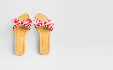 Women's red stripy bow sandals on white background with copy space for text.