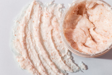 Face Skin Scrub sample and container with scrub on light background