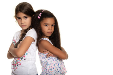 Two sad and angry small girls on a white background - Powered by Adobe