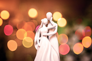 Wedding cake top with bride and groom figure in modern style.