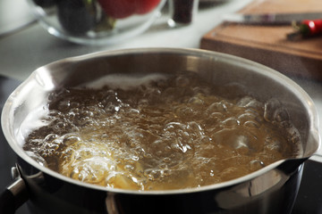 Cooking pasta in pot on stove, closeup