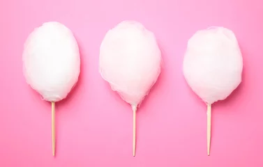 Selbstklebende Fototapeten Sticks with yummy cotton candy on color background, top view © New Africa