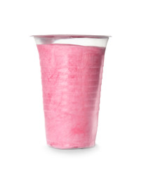 Yummy cotton candy in plastic cup on white background