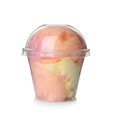 Yummy cotton candy in plastic cup on white background