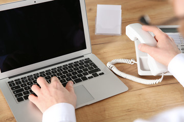 Male technical support operator working in office, closeup of hands