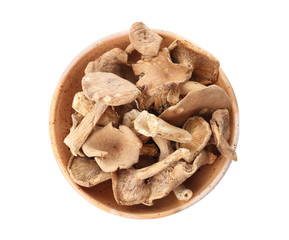 Bowl of dried mushrooms isolated on white, top view
