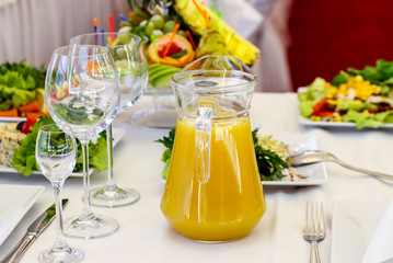 Served dishes to the table for holiday. Cutlery and food on white tablecloths in the restaurant. Design a festive Banquet. Luxurious food for guests and visitors.