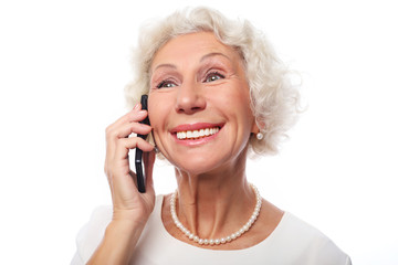 technology, communication age and people concept: happy senior woman with smartphoneover white background