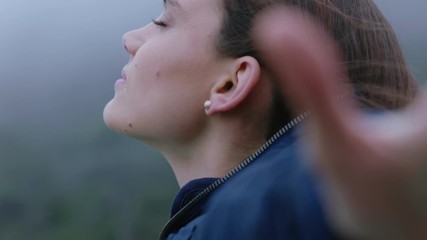 portrait of beautiful woman smiling enjoying peaceful countryside exploring freedom on vacation travel adventure with wind blowing hair