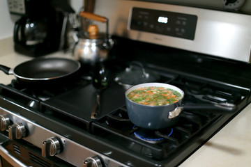 Pot of vegetable soup cooking on the stove.