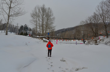Woman walking at snow village in China