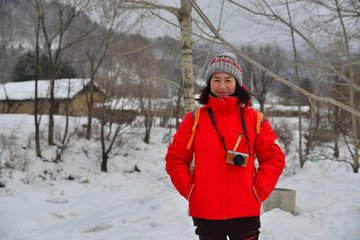 Fototapeta na wymiar Woman walking at snow village in China