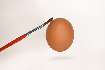 brown egg and tassel. Painting eggs before Easter.