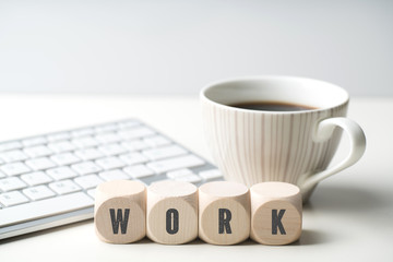 cubes with word "work" in front of a computer keyboard