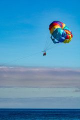 Sea and beach sport for tourists, parasailing in blue sky