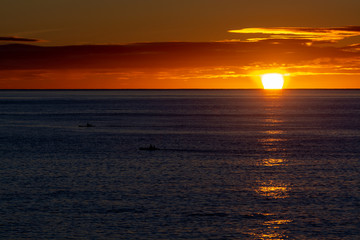 Scenic colorful sunrise over dark blue ocean water