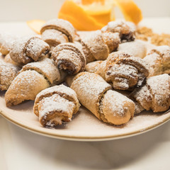 Homemade cookies with orange jam. Traditional Christmas cookies with jam and walnuts on white background. Home made biscuits. Holiday concept.