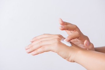 Healthcare concept. Closeup shot of  young woman hands applying moisturizing hand cream.