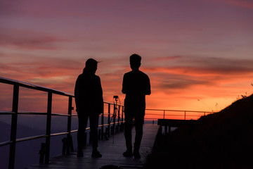 Fototapeta na wymiar Young couple enjoying the sunset on the Viewpoint