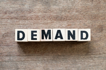 Letter block in word demand on wood background