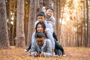 Fototapeta premium Young family with children having fun in nature