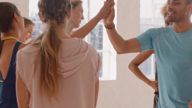 dance class happy group of dancers high five enjoying successful routine resting after intense  training practice celebrating achievement in studio