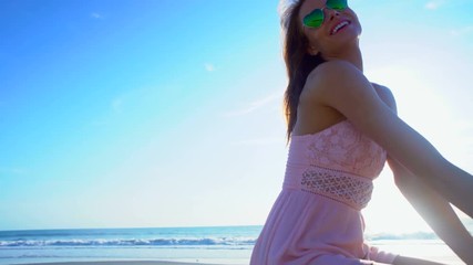 Attractive Caucasian American woman relaxing on ocean beach 