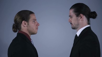 Confident serious Caucasian American executive managers standing face to face