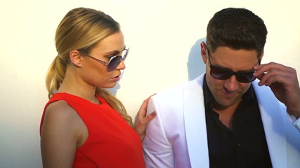 Attractive Caucasian male and female models in fashionable clothes outdoors