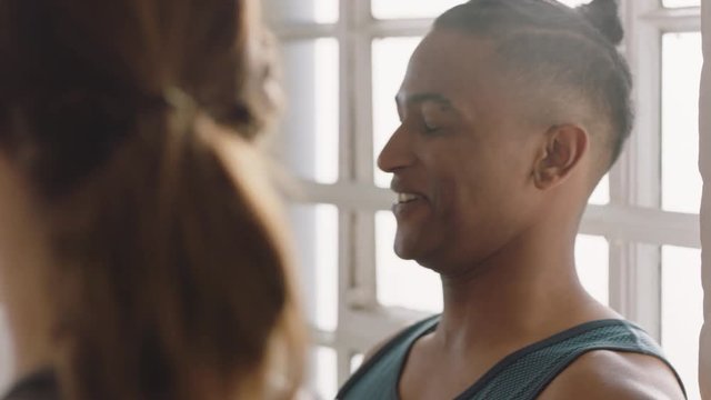 dance class multiracial friends chatting discussing fitness lifestyle sharing training tips enjoying conversation in workout studio 
