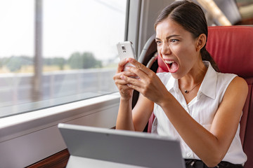Angry Asian business woman upset screaming at phone call for communication problem or wifi internet...
