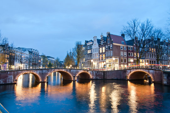 Keizersgracht inersection bridge view of Amsterdam canal and historical houses during twilight time, Netherland.