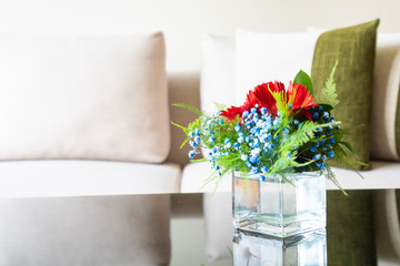 Vase flower on table with pillow on sofa decoration