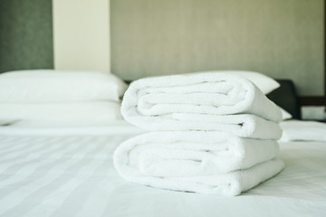 Fototapeta na wymiar White towel on bed decoration interior
