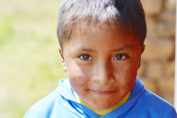 Smiling native american kid outside.