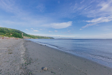 Empty beach by sea in Discovery Park of Seattle, USA