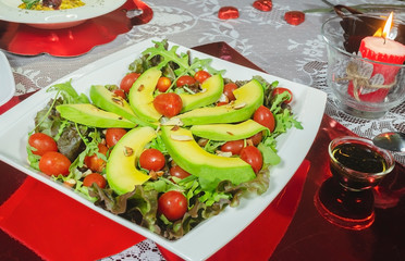 healthy avocado dish, cherry tomatoes, almond lettuce and for romantic dinner