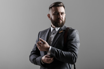 Portrait of a stylish man with a beard on white background