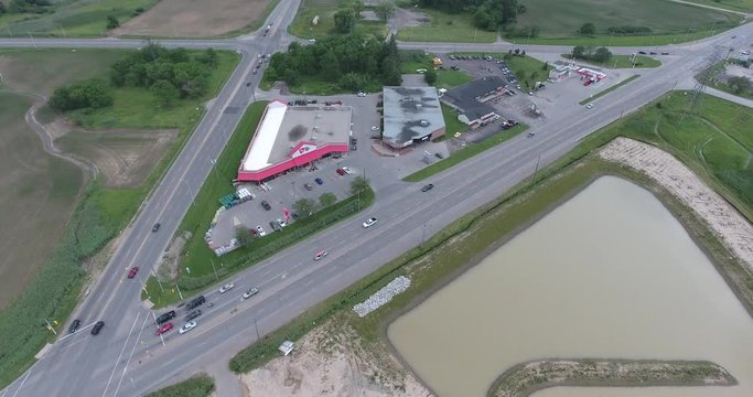Triangle Shaped Mini Plaza With Hardware Store And Gas Station Aerial View