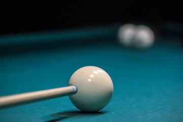the cue is aimed at the white ball, accurate blow to the ball. to score in a pocket, to win.