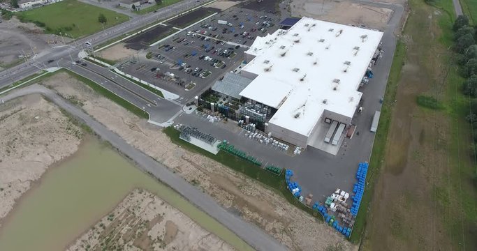 Flying Towards Newly Constructed Hardware Big Box Store With Farmland Around Aerial 002