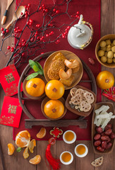 Obraz na płótnie Canvas Flat lay Chinese new year food and drink still life. Translation of text in image: Prosperity.