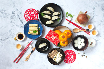 Flat lay Chinese new year food and drink on marble table top.