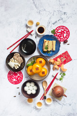 Flat lay Chinese new year food and drink on marble table top.