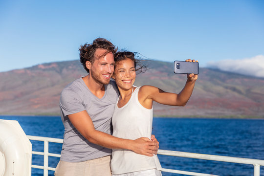 Cruise ship couple taking selfie phone photo Travel in Hawaii holiday. Two tourists lovers on honeymoon travel enjoying summer vacation.