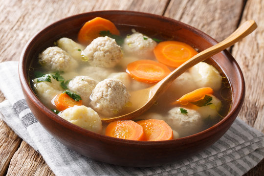 Delicious Danish soup with meat balls, dumplings and vegetables close-up in a bowl. horizontal