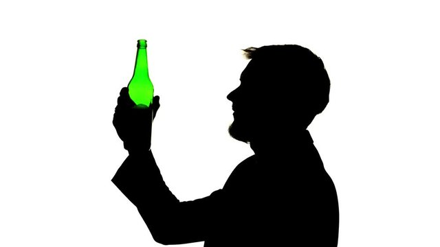 Guy drank a beer and his head ached. Side view. Silhouette White background
